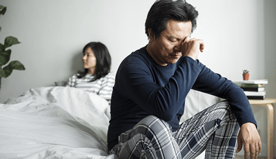 Man in bed with wife - frustrated - narrow