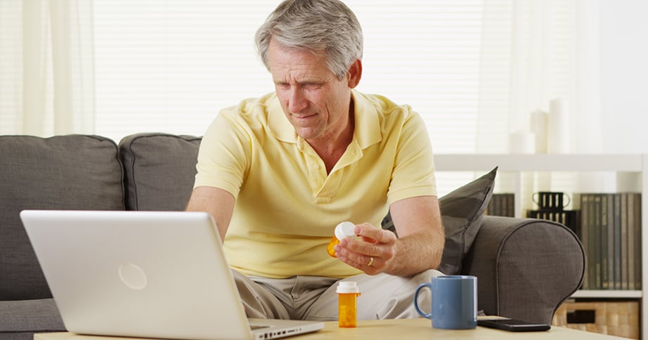 Man looking up info on prescription